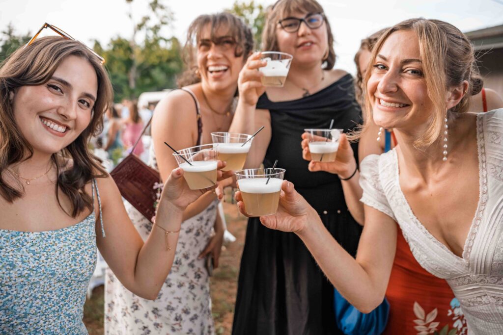 Friends with their drinks at a wedding pre-party at The Preserve at Chocorua in Tamworth, New Hampshire